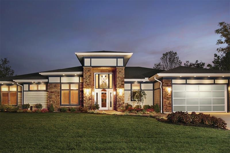 Modern ranch-style home with bright entry and glass garage.