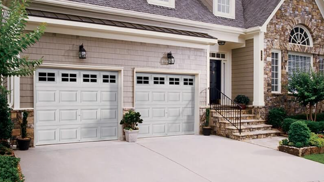 Suburban home with double garage doors and driveway.
